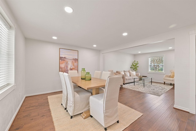 dining area with baseboards, wood finished floors, and recessed lighting