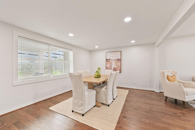 dining room with baseboards, wood finished floors, and recessed lighting