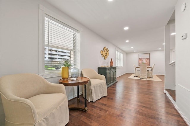 living area with dark wood-style floors, baseboards, and recessed lighting