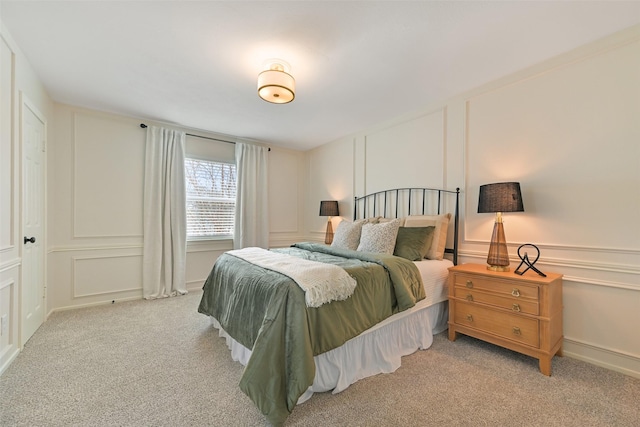 carpeted bedroom with a decorative wall