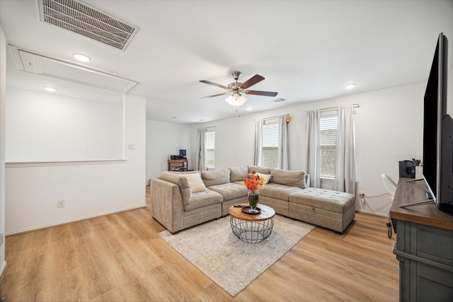 living room featuring ceiling fan and light hardwood / wood-style flooring