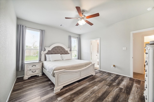 bedroom with ceiling fan, multiple windows, and dark hardwood / wood-style flooring