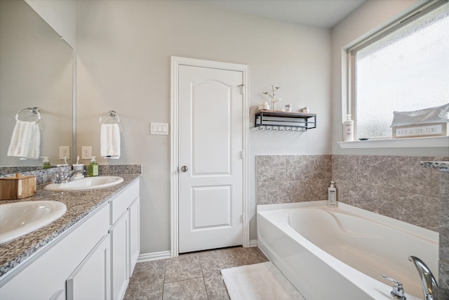 bathroom with vanity, tile patterned flooring, and a bathing tub