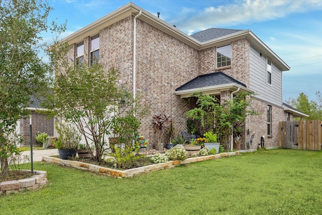 rear view of property with a yard