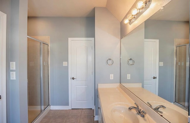 bathroom with vanity, a shower with shower door, and tile patterned flooring