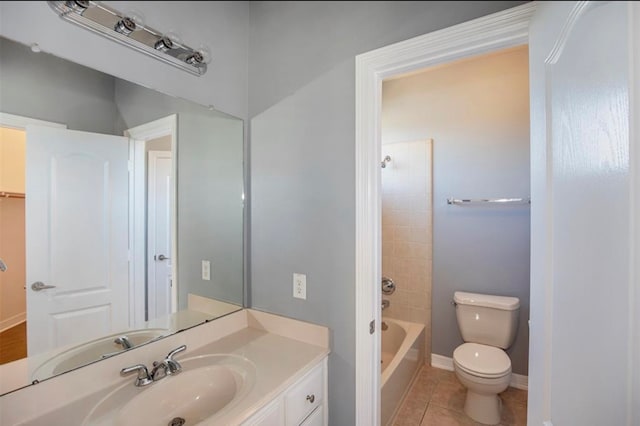 full bathroom featuring vanity, tile patterned floors, tiled shower / bath, and toilet