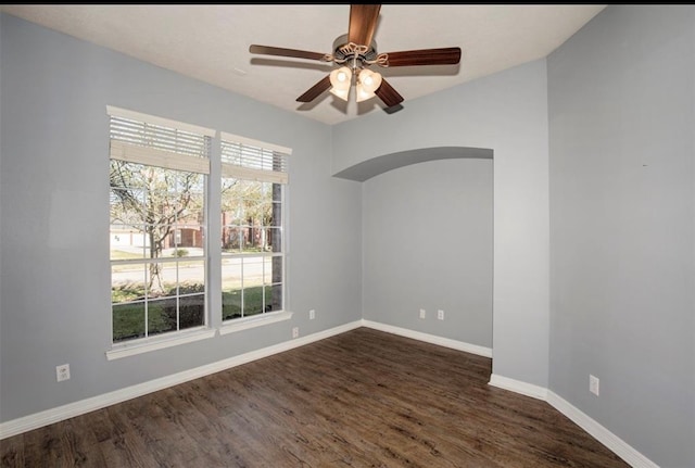 empty room featuring ceiling fan and dark hardwood / wood-style flooring