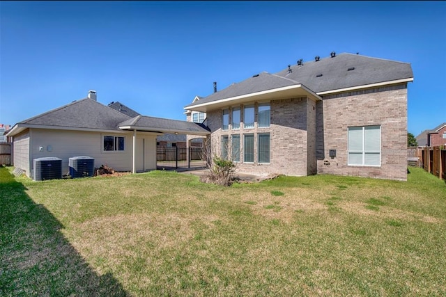 back of house featuring a patio, a lawn, and central air condition unit