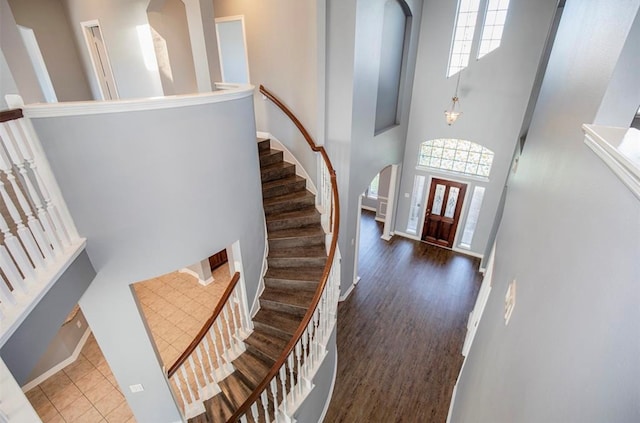 entryway with a towering ceiling and dark hardwood / wood-style floors