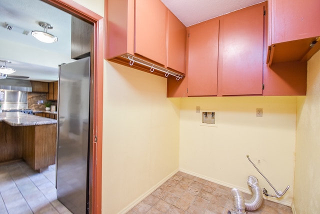 laundry room with hookup for a washing machine and cabinets