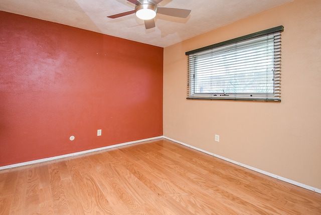 unfurnished room with ceiling fan and light wood-type flooring