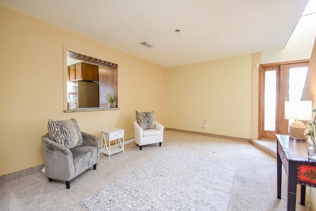 living area with light carpet