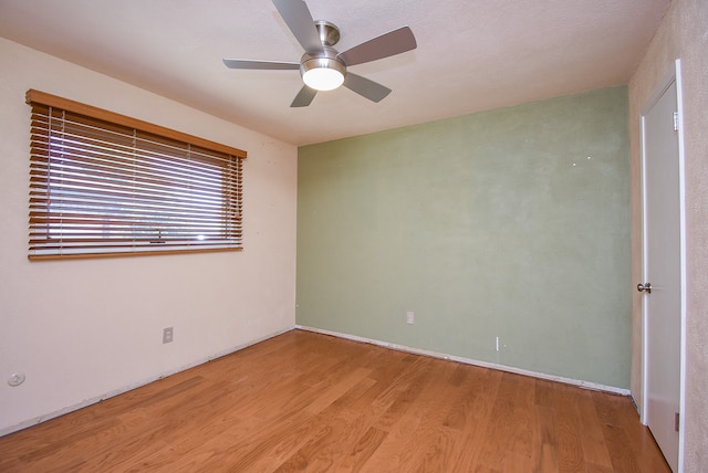 empty room with light hardwood / wood-style floors and ceiling fan