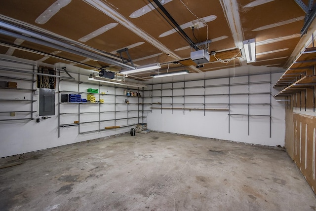 garage featuring electric panel and a garage door opener