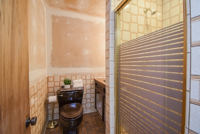 bathroom featuring tile walls and a shower with shower door