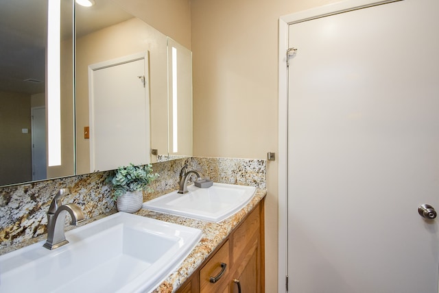 bathroom featuring vanity and backsplash