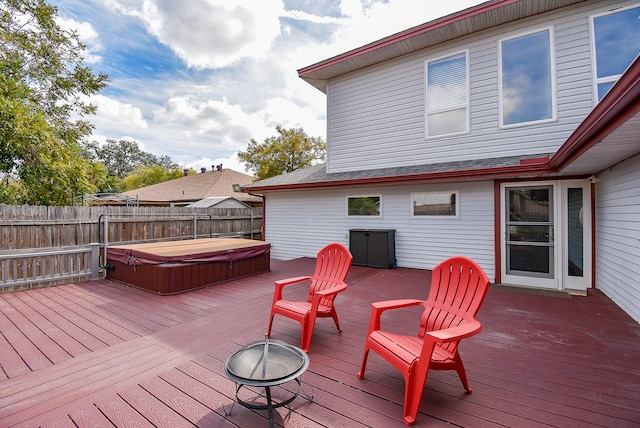 wooden deck featuring a covered hot tub