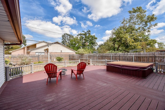 wooden terrace featuring a covered hot tub