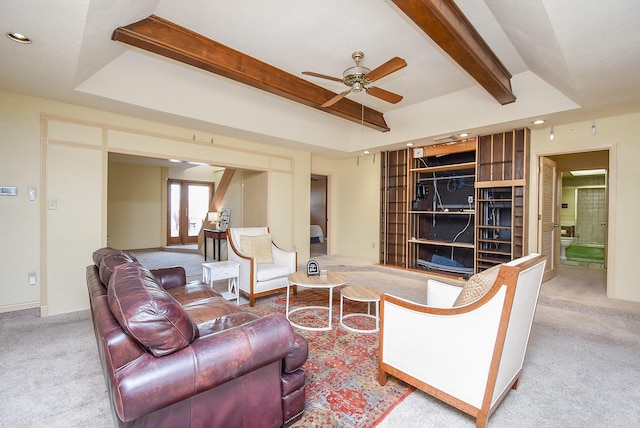 carpeted living room featuring beamed ceiling, ceiling fan, and french doors