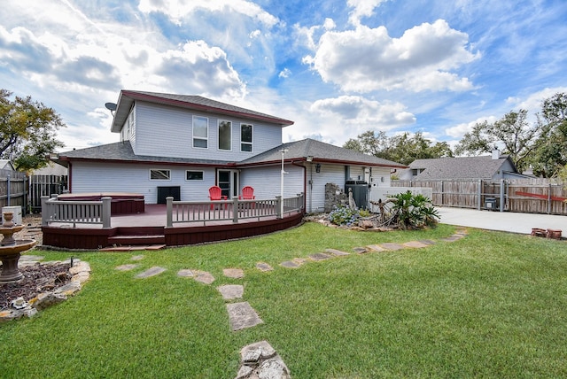 back of house with a wooden deck, central AC, a patio area, a hot tub, and a lawn