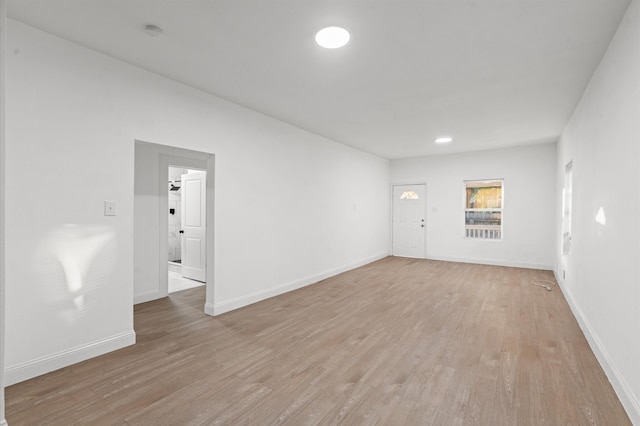 empty room with light hardwood / wood-style flooring