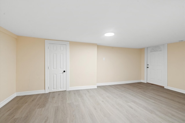 basement with light hardwood / wood-style flooring