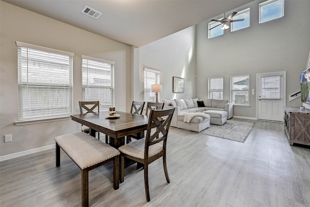 dining area with light hardwood / wood-style floors and a healthy amount of sunlight