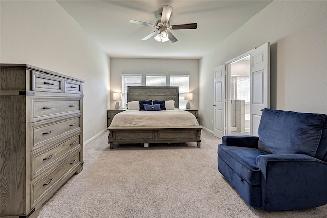 carpeted bedroom with connected bathroom and ceiling fan