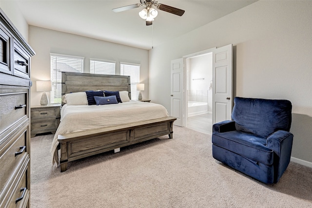 carpeted bedroom with connected bathroom and ceiling fan