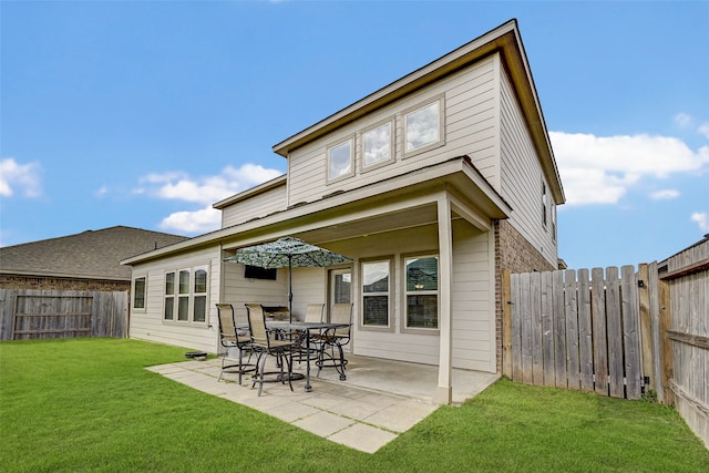 back of house featuring a patio and a lawn