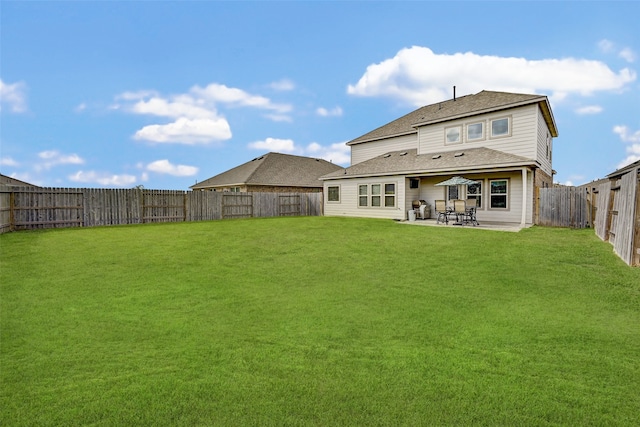 rear view of house featuring a patio and a lawn