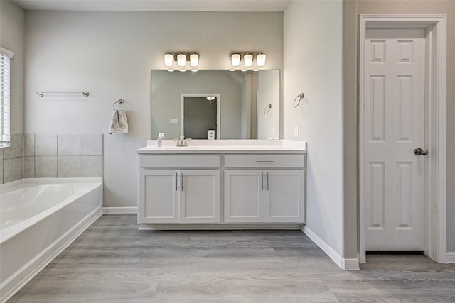 bathroom with vanity, wood-type flooring, and a bathing tub