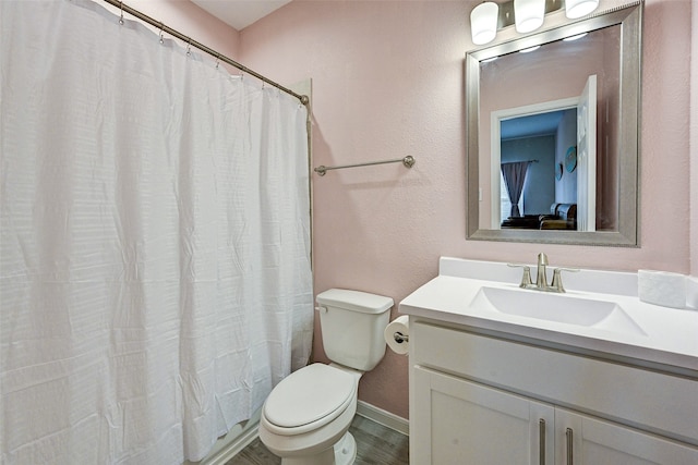 bathroom featuring vanity, walk in shower, hardwood / wood-style flooring, and toilet