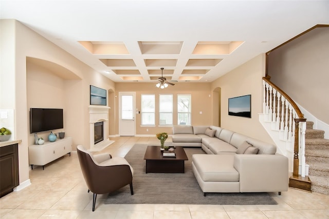 living room with coffered ceiling, beam ceiling, ceiling fan, and light tile patterned flooring