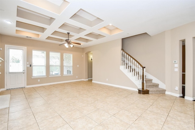 unfurnished living room featuring beamed ceiling, ceiling fan, coffered ceiling, and light tile patterned floors