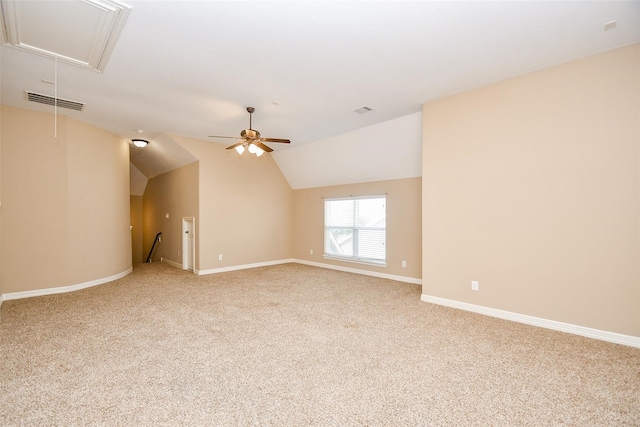 carpeted empty room with vaulted ceiling and ceiling fan