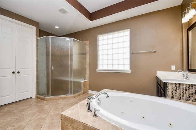 bathroom featuring tile patterned flooring, vanity, and separate shower and tub