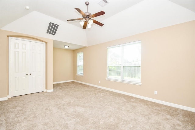 unfurnished bedroom with ceiling fan, a closet, and light carpet