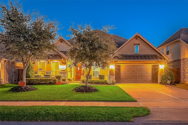 view of front of home with a front yard and a garage