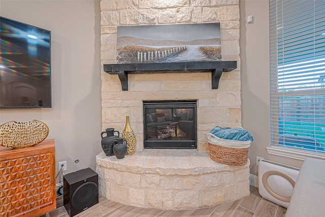 interior details featuring a stone fireplace and hardwood / wood-style floors