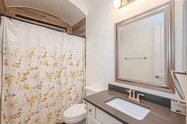 bathroom featuring toilet, curtained shower, and vanity