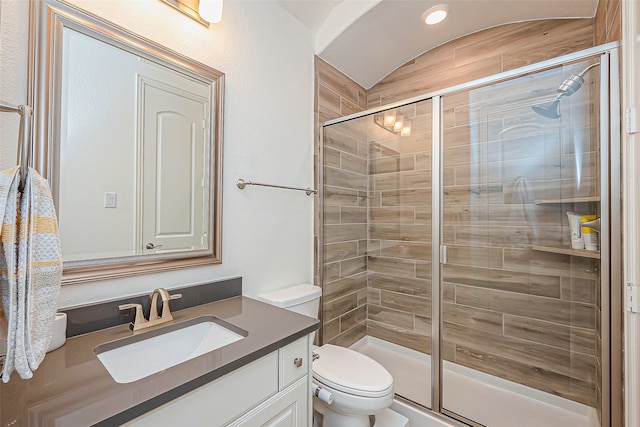 bathroom featuring toilet, an enclosed shower, and vanity