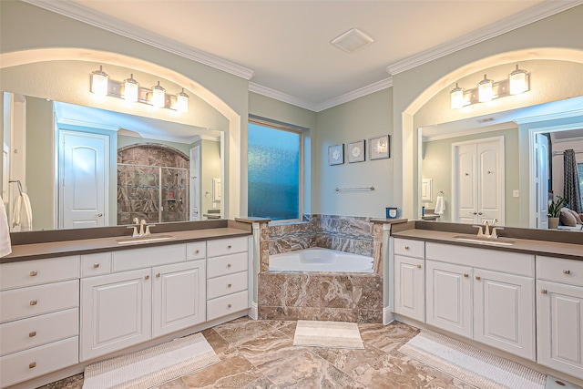 bathroom featuring vanity, crown molding, and separate shower and tub