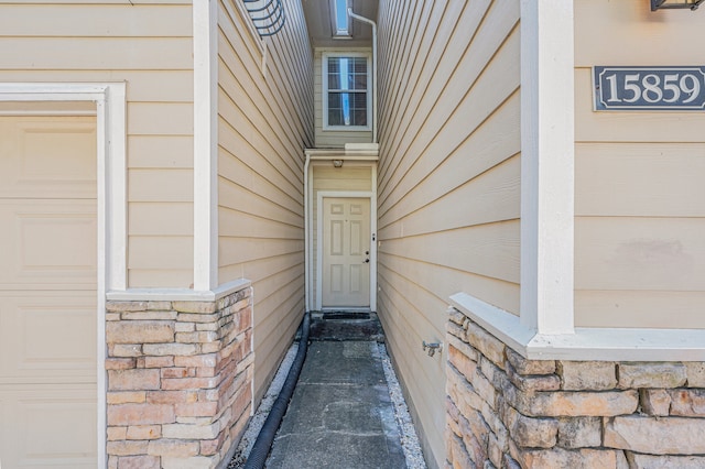 doorway to property with a garage