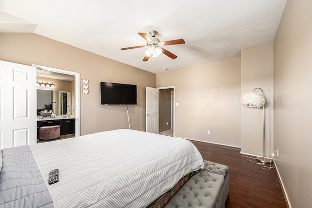 bedroom featuring ensuite bathroom, dark wood-type flooring, vaulted ceiling, and ceiling fan