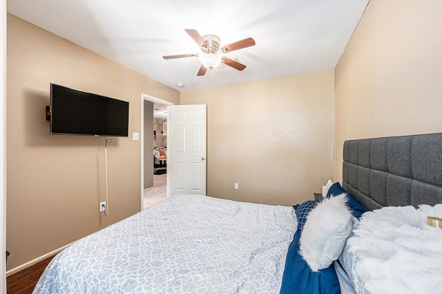 bedroom with wood-type flooring and ceiling fan