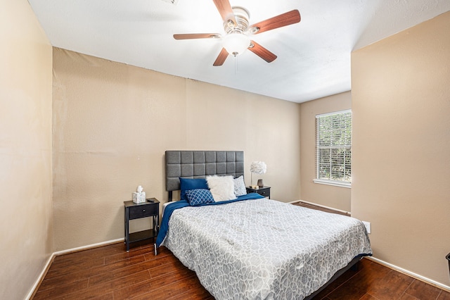 bedroom with dark hardwood / wood-style floors and ceiling fan