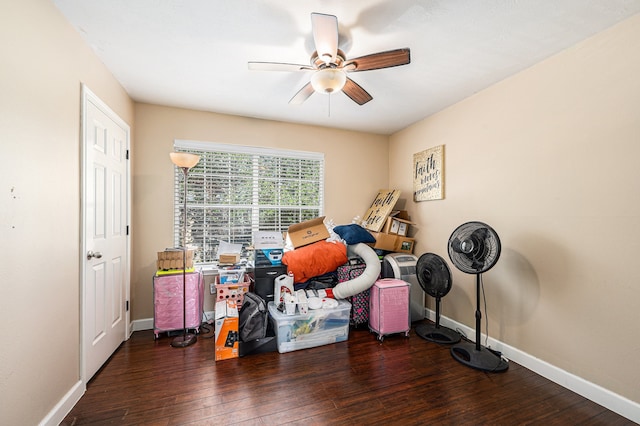 misc room with dark wood-type flooring and ceiling fan