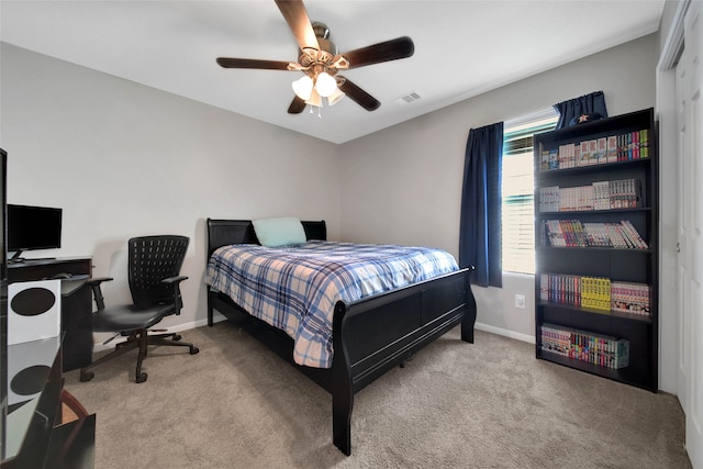 bedroom with a closet, ceiling fan, and light carpet