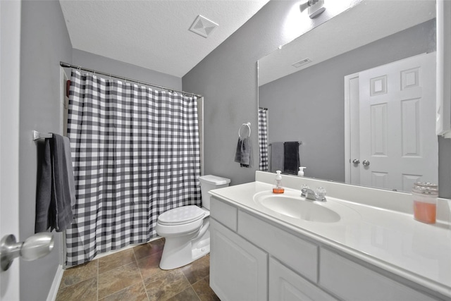 9924 Lace Flower Way, Conroe, TX 77385 - full bathroom featuring toilet, vanity, stone finish flooring, a shower with shower curtain, and a textured ceiling